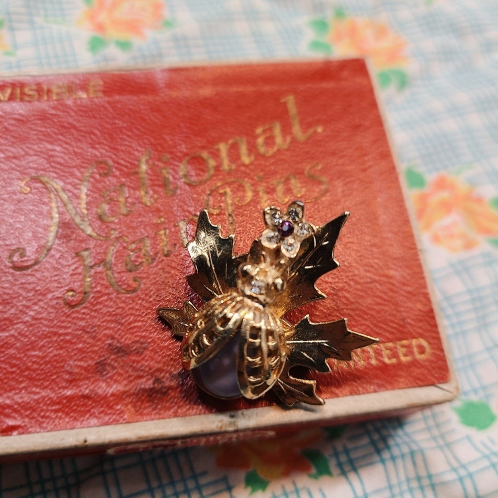 Beautiful beetle broach with a lavender stones.